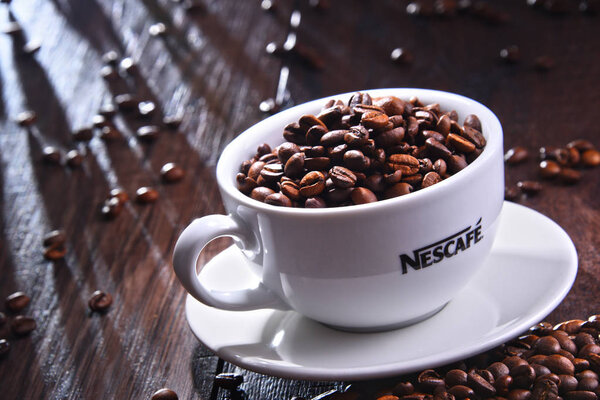 Composition with cup of Nescafe coffee beans