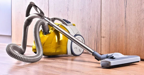 Canister vacuum cleaner for home use on the floor panels — Stock Photo, Image