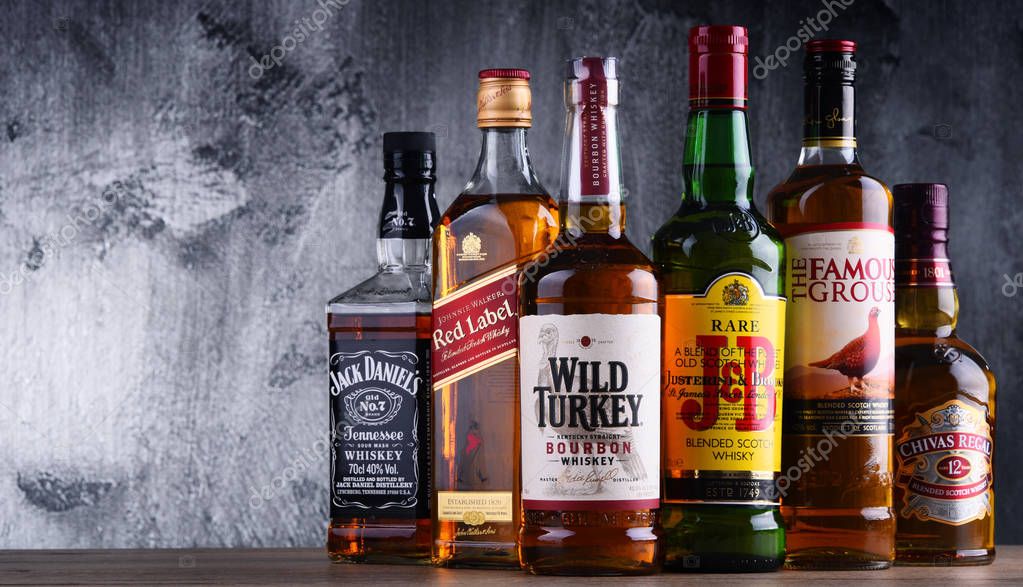 POZNAN, POLAND - MAR 30, 2018: Bottles of several global whiskey brands, the most popular liquor in the world.