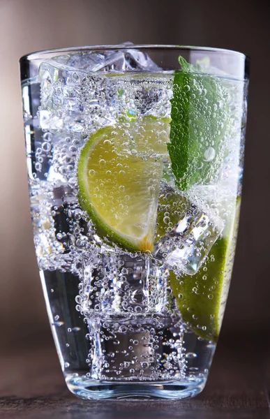 Glass of mineral water with ice, lime and mint — Stock Photo, Image