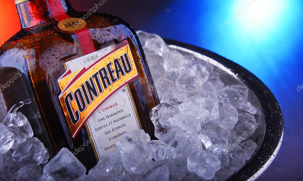 POZNAN, POL - NOV 21, 2019: Bottle of Cointreau, a brand of French triple sec (an orange-flavoured liqueur); great component of several well-known cocktails, also drunk as an aperitif and digestif