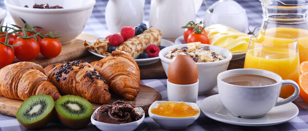 Breakfast served with coffee, juice, croissants and fruits
