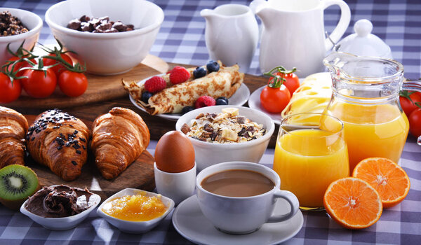 Breakfast served with coffee, juice, croissants and fruits