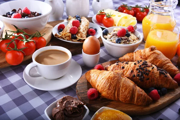 Café da manhã servido com café, suco, croissants e frutas — Fotografia de Stock