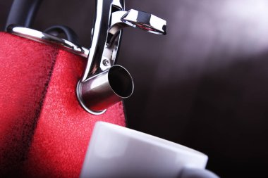 Kırmızı paslanmaz çelik soba ıslıkla ısıtılıyor.