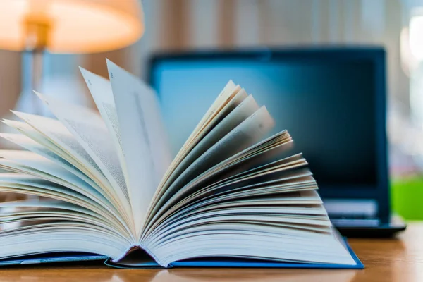 Open book lying on the table in the library — Stock Photo, Image