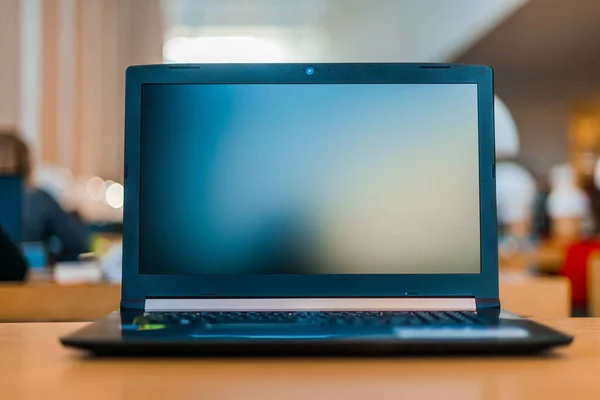 Laptop computer on the desk in public library — Stock Photo, Image