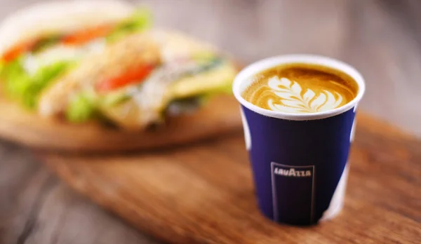 Cup of Lavazza coffee and sandwiches — 스톡 사진