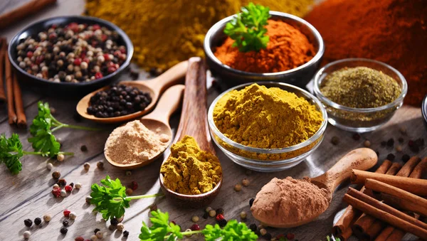 Variety of spices on kitchen table — Stock Photo, Image