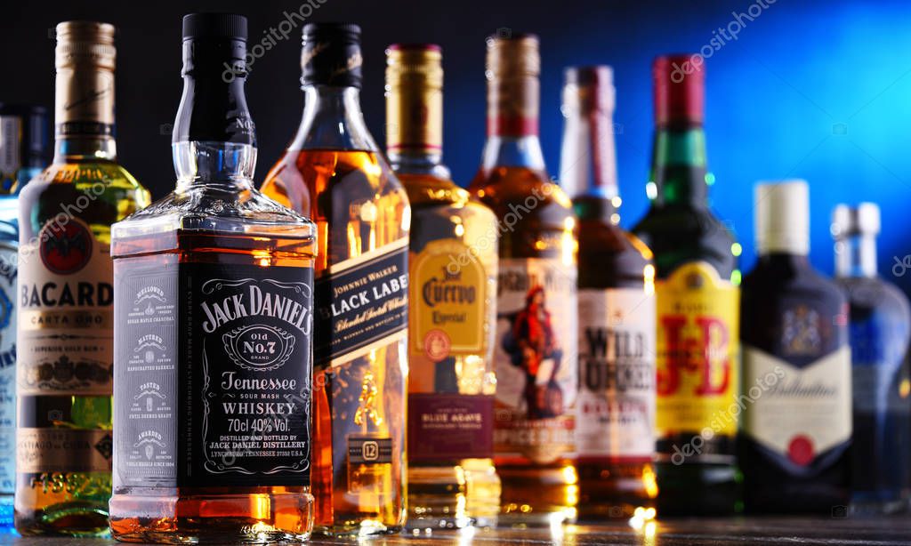 POZNAN, POLAND - DEC 20, 2019: Bottles of assorted global liquor brands including whiskey, vodka, gin and liqueur