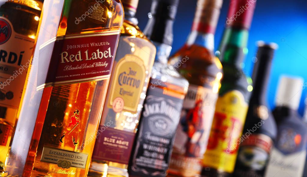 POZNAN, POLAND - DEC 20, 2019: Bottles of assorted global liquor brands including whiskey, vodka, gin and liqueur
