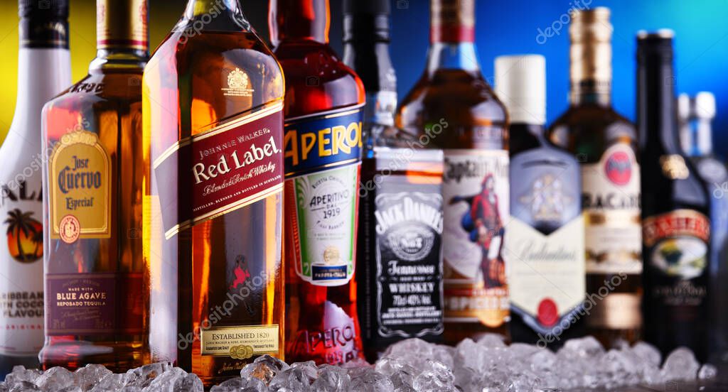 POZNAN, POLAND - DEC 20, 2019: Bottles of assorted global liquor brands including whiskey, vodka, gin and liqueur