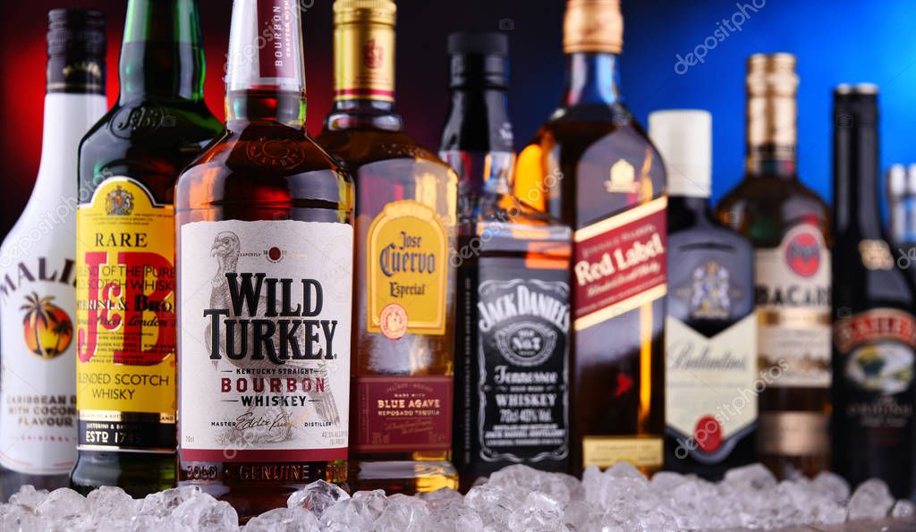 POZNAN, POLAND - DEC 20, 2019: Bottles of assorted global liquor brands including whiskey, vodka, gin and liqueur