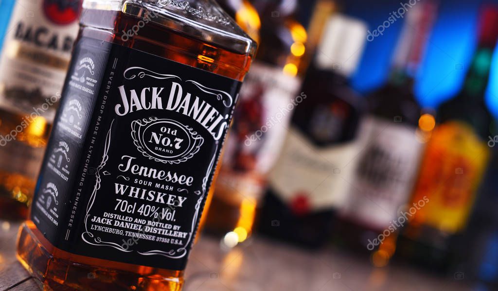 POZNAN, POLAND - DEC 20, 2019: Bottles of assorted global liquor brands including whiskey, vodka, gin and liqueur
