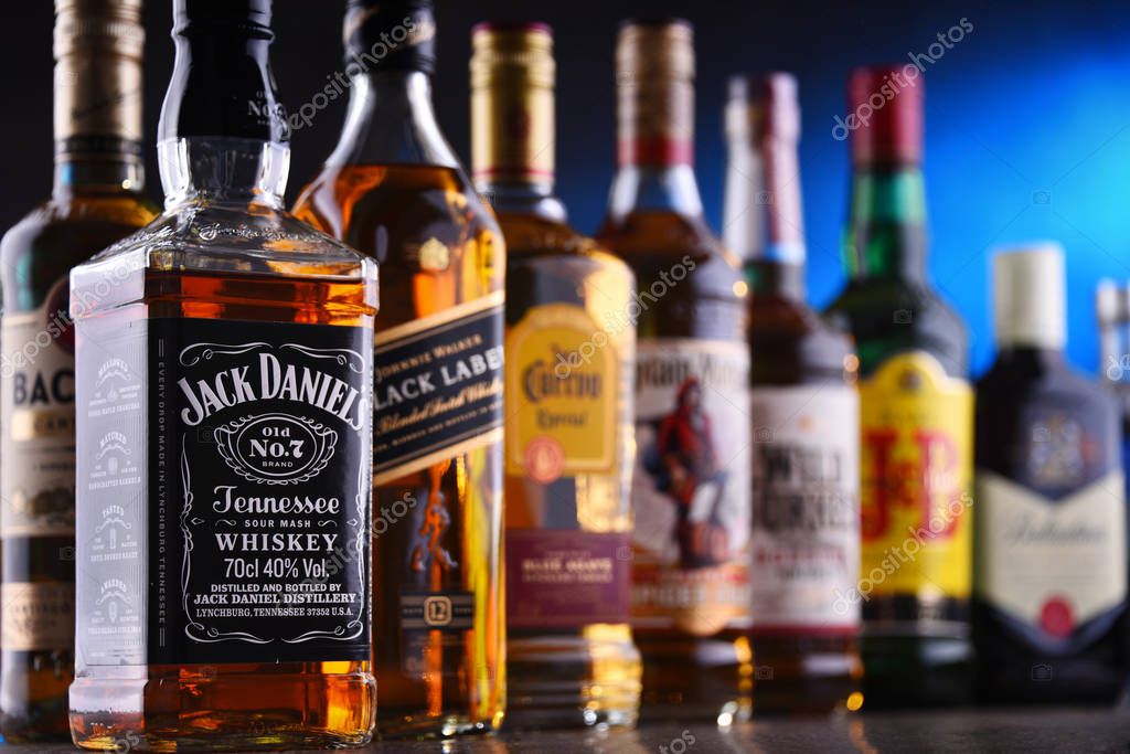 POZNAN, POLAND - DEC 20, 2019: Bottles of assorted global liquor brands including whiskey, vodka, gin and liqueur