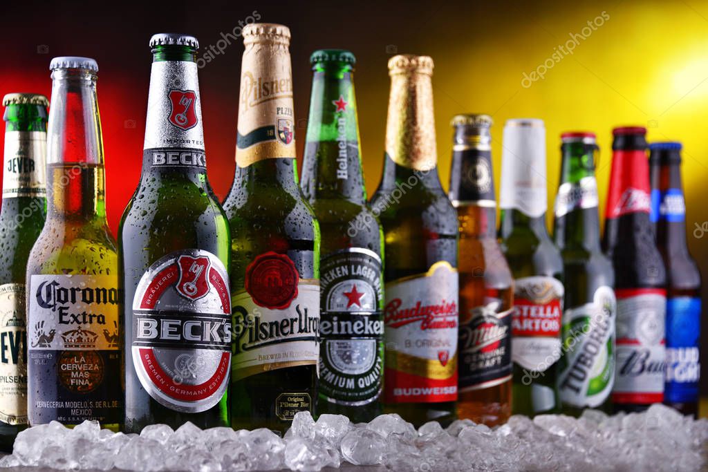 POZNAN, POL - DEC 23, 2019: Bottles of famous global beer brands including Heineken, Becks, Bud, Miller, Corona, Stella Artois, and Pilsner Urquell