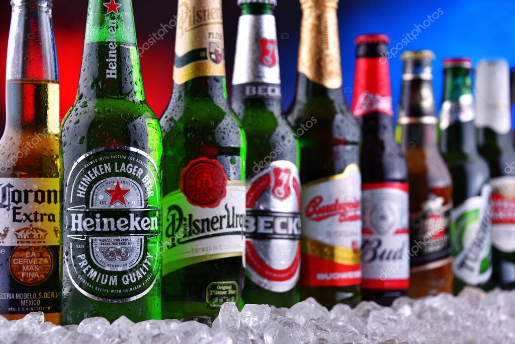 POZNAN, POL - DEC 23, 2019: Bottles of famous global beer brands including Heineken, Becks, Bud, Miller, Corona, Stella Artois, and Pilsner Urquell
