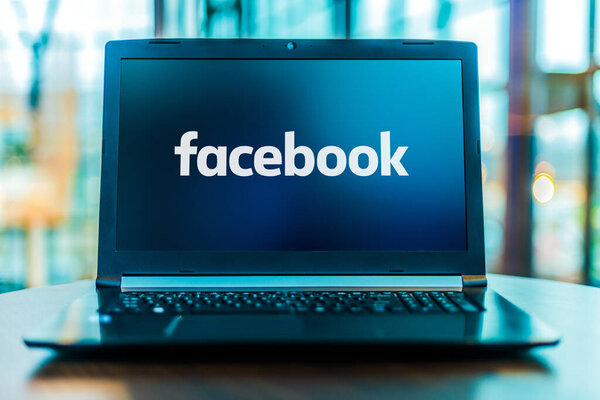 POZNAN, POL - MAR 24, 2020: Laptop computer displaying logo of Facebook, an American online social media and social networking service company based in Menlo Park, California