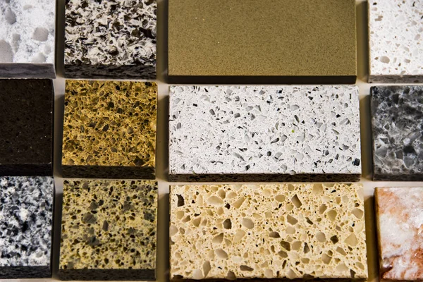 Samples of natural stone in different sizes used as a kitchen counter tops. Granite, quartz and marble countertops — Stock Photo, Image