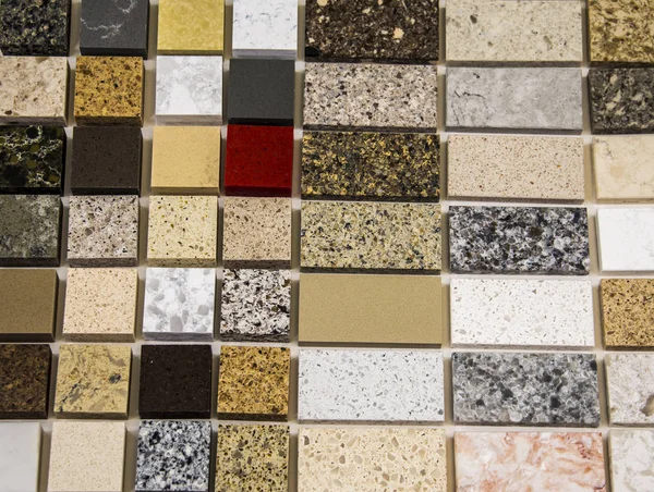 Colorful samples of natural stone in different sizes used as a kitchen counter tops. Granite, quartz and marble countertops