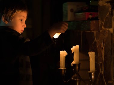 Küçük şirin çocuk Mumluk mum dışarı darbeler. Konsept fotoğraf vintage, evim güzel evim, dünya, eğitim, Orijinallik Sertifikası bilgisi.