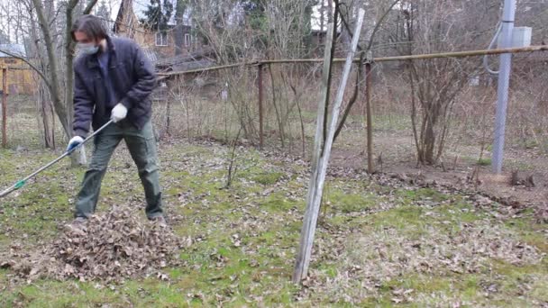 Young Man Disposable Mask Protect Coronavirus Conducts Spring Cleaning Garden — Stock Video