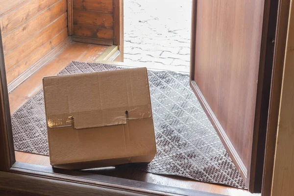 Contactless delivery, View from inside through open door. parcel delivered and left outside entrance door. Apartment entrance with delivered box. Control Epidemic Prevention measures of coronavirus