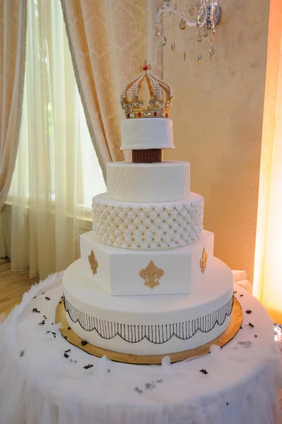 Wedding cake with luxury decorated in wedding party. Cake decorated with crown