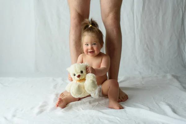Little Girl Sits Happy White Background Legs Her Father — Stock Photo, Image