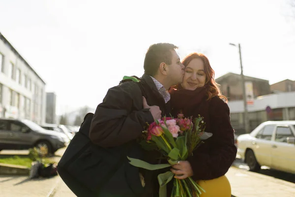 Young Guy Gives Flowers Kisses His Beloved — Stock Photo, Image