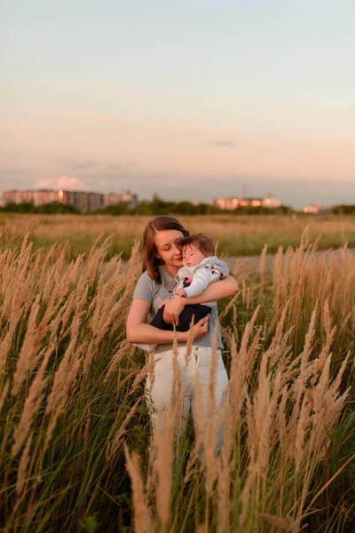 Een Moeder Loopt Het Veld Met Haar Dochtertje Haar Armen — Stockfoto