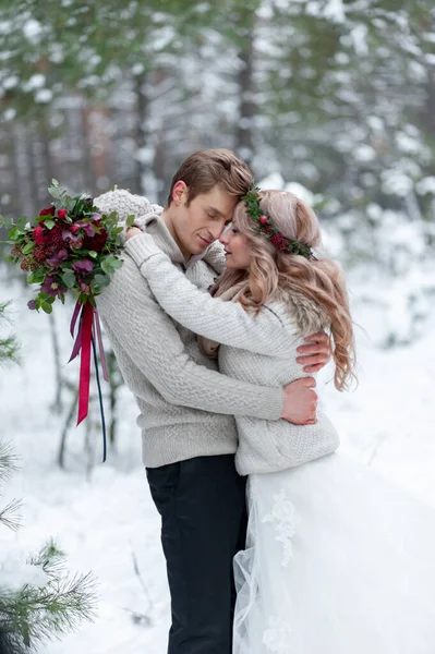 新娘和新郎带着乡村的花束出现在冬季森林的背景上 冬季婚礼 — 图库照片
