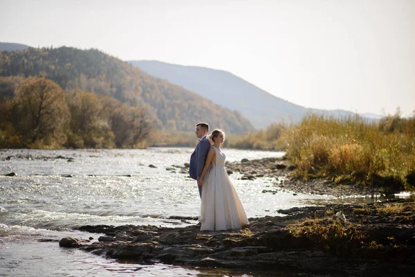 Wedding photo session of the bride and groom in the mountains. Photoshoot at sunset.