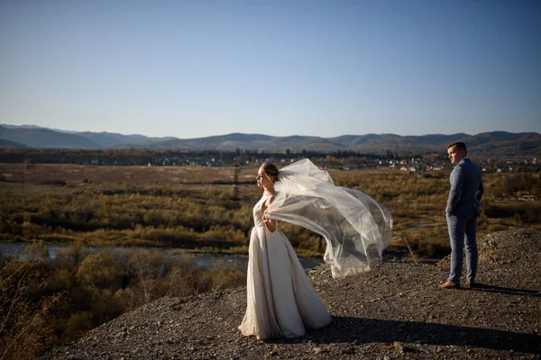 Wedding photo session of the bride and groom in the mountains. Photoshoot at sunset.