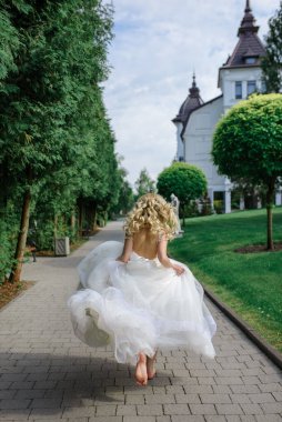 Portrait of a beautiful blonde bride. A woman runs away from her wedding. clipart