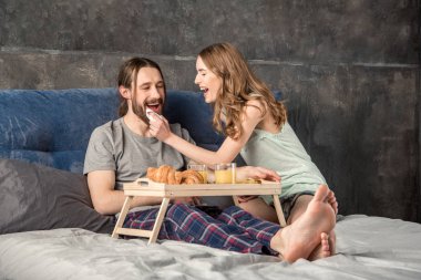 Couple has breakfast in bed clipart