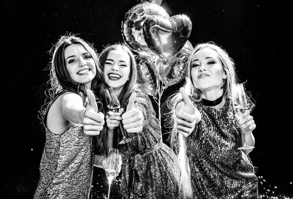 Women showing thumbs up