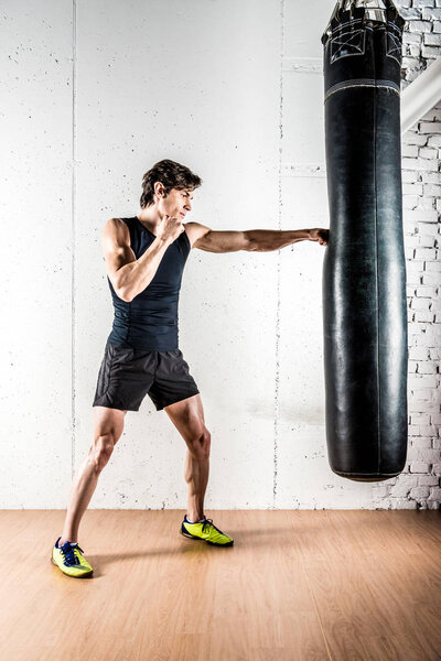 Kickboxer boxing in punching bag