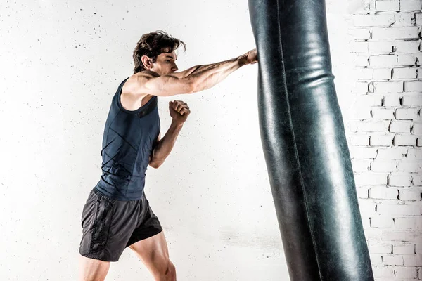 Kickboxer boxing in punching bag — Stock Photo, Image