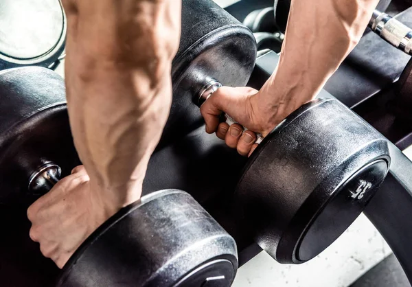 Dumbbells in male hands — Stock Photo, Image