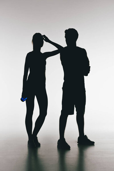 silhouettes of young fit couple