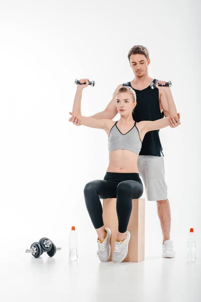 Girl doing exercise with trainer — Stock Photo, Image