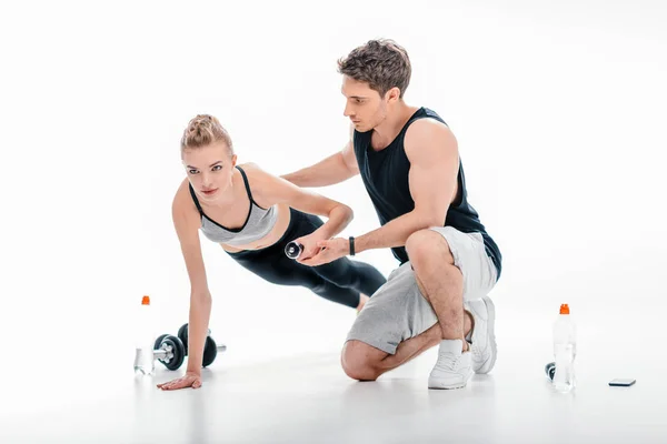 Girl doing exercise with trainer — Stock Photo, Image