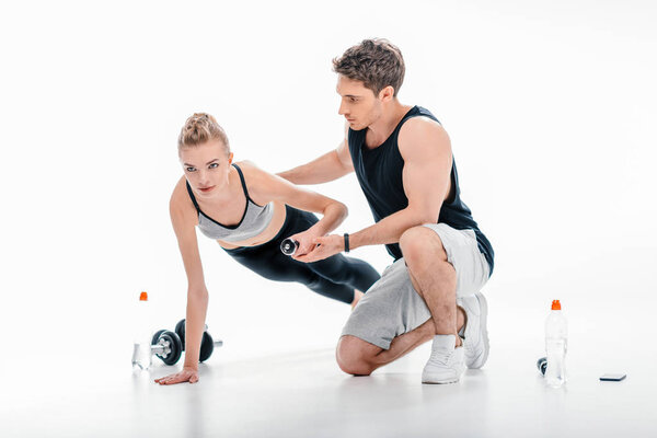 girl doing exercise with trainer
