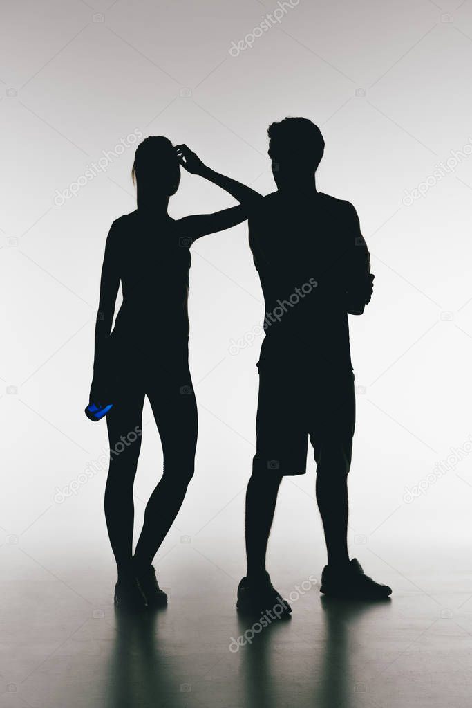 silhouettes of young fit couple