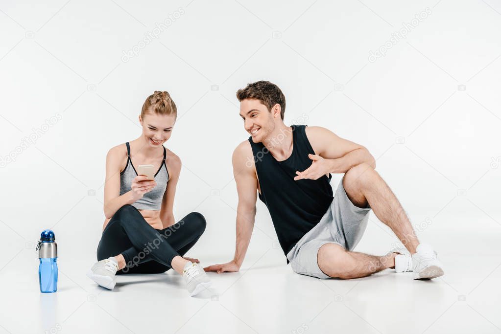 couple looking at phone after workout