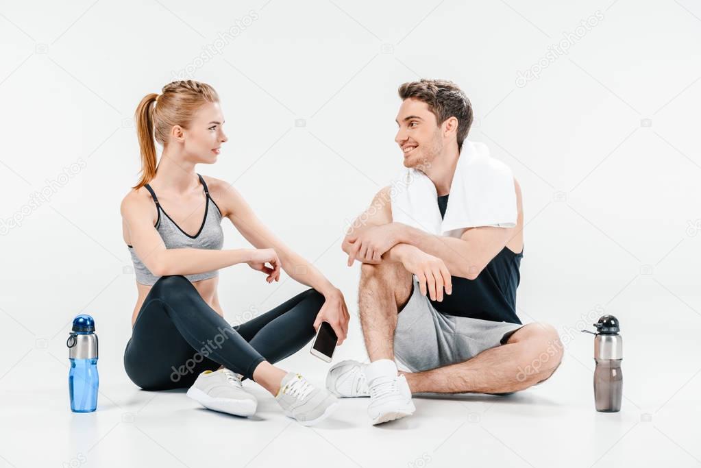 man and woman talking after workout