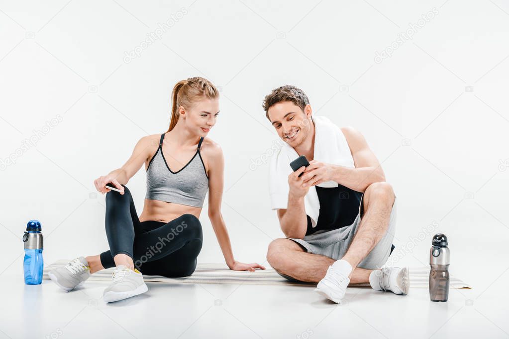 couple looking at phone after workout