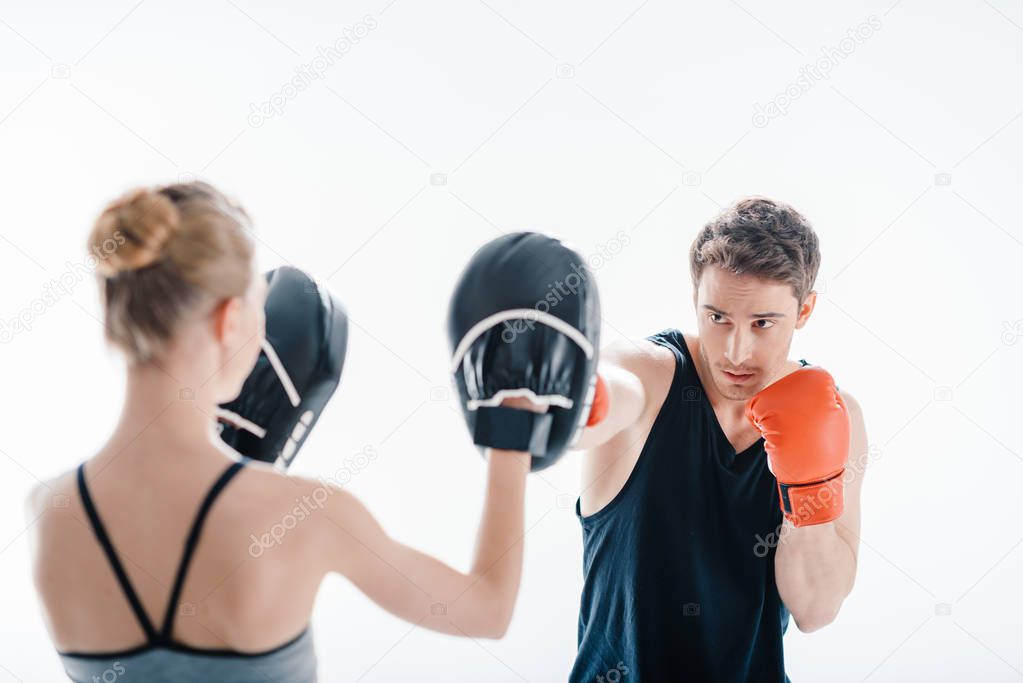 man boxing with female trainer