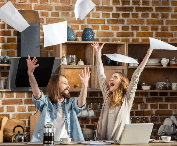 Young couple throwing documents — Stock Photo